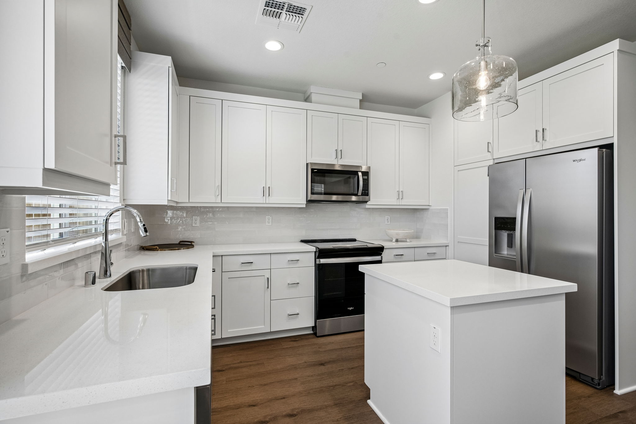 Kitchen with white cabinets, Island and stainless steel appliances
