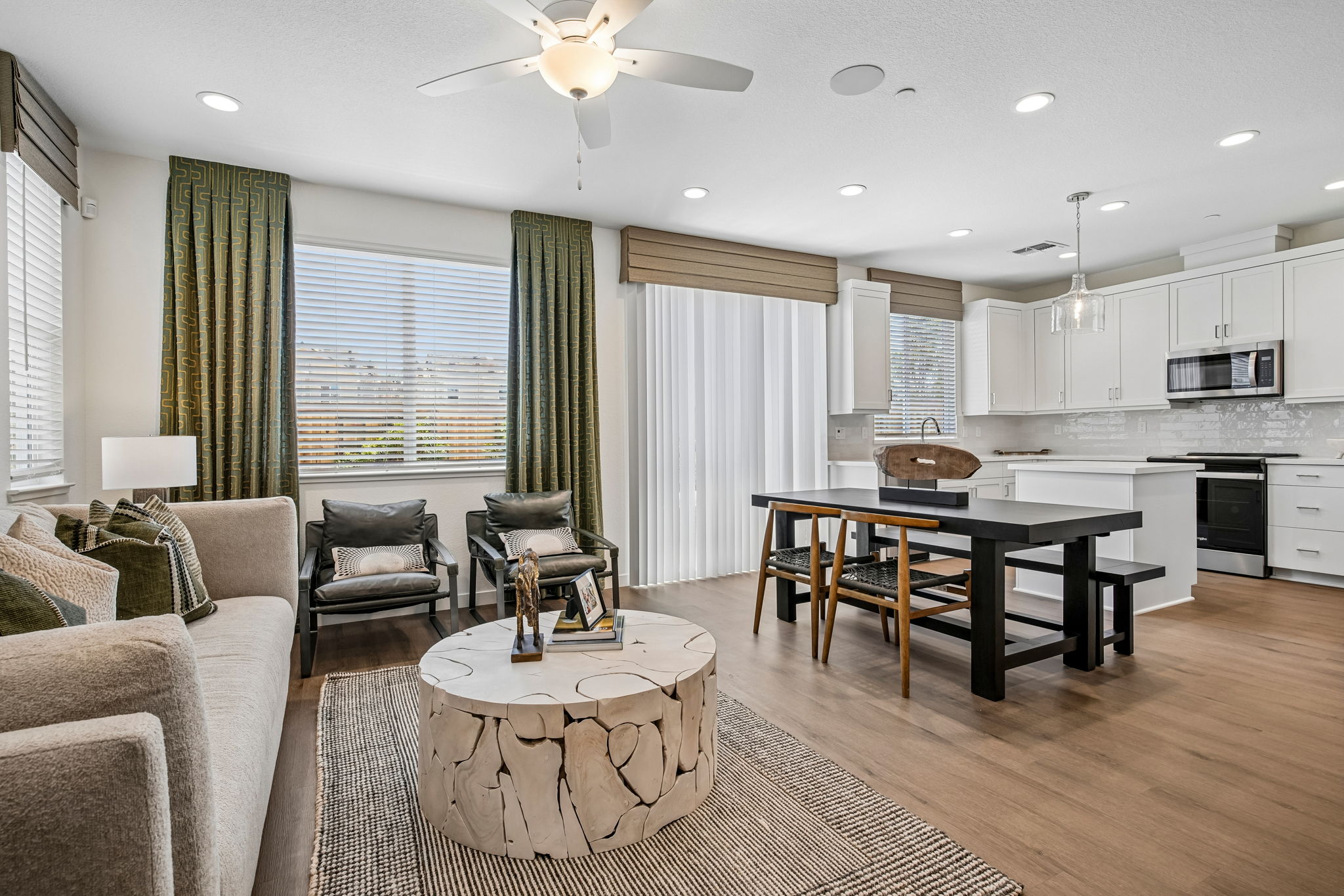 Living area with sofa, tv, and coffee table with view of breakfast bar and kitchen