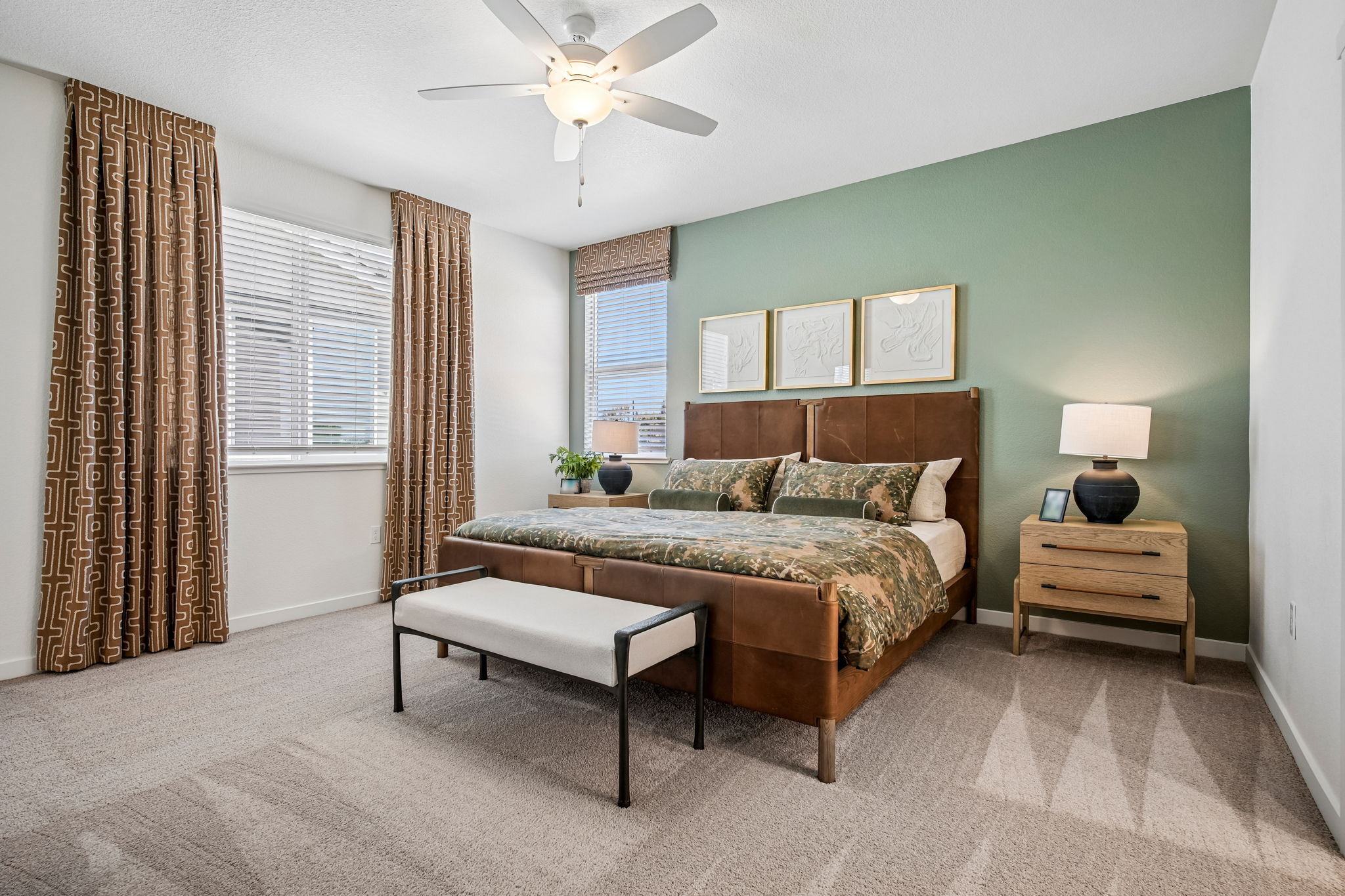 Bedroom with bed, large window, chair and table with lamp