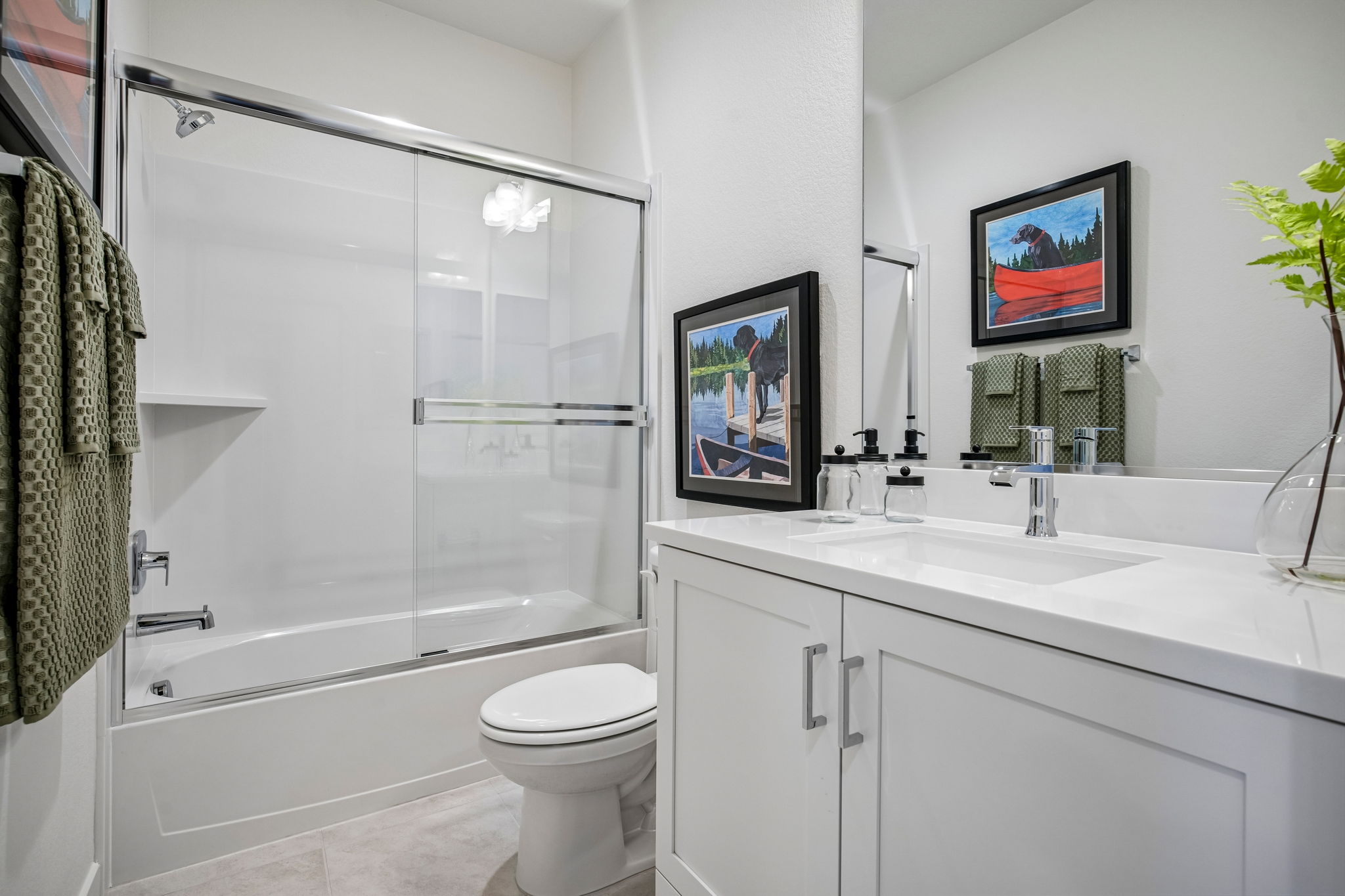 Bathroom with white vanity and shower tub combo