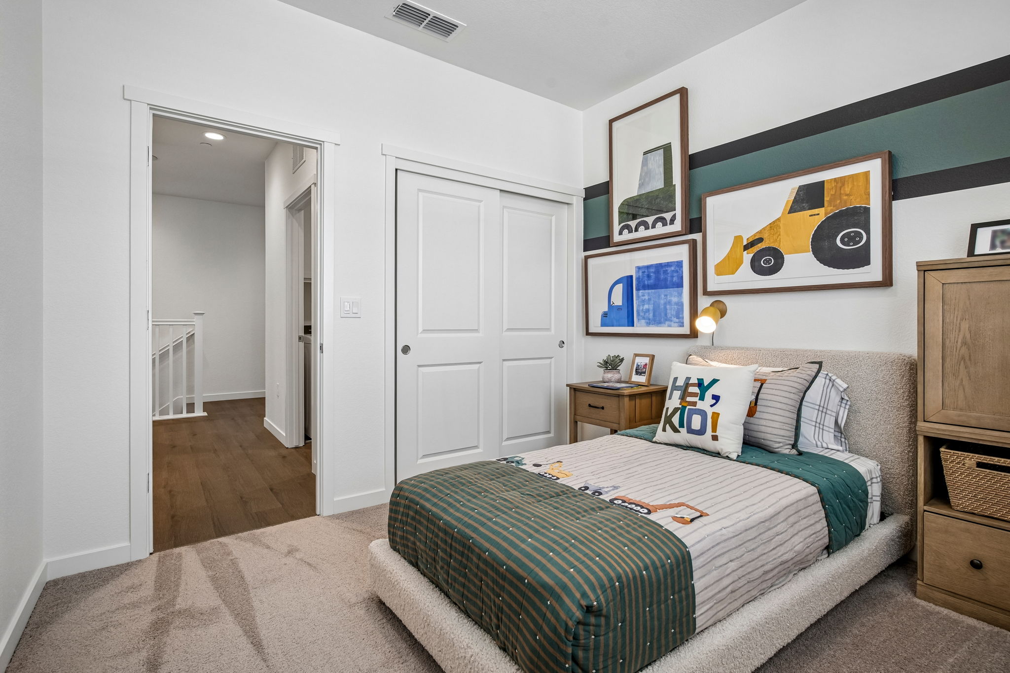 Bedroom with bed, closet and table with lamp