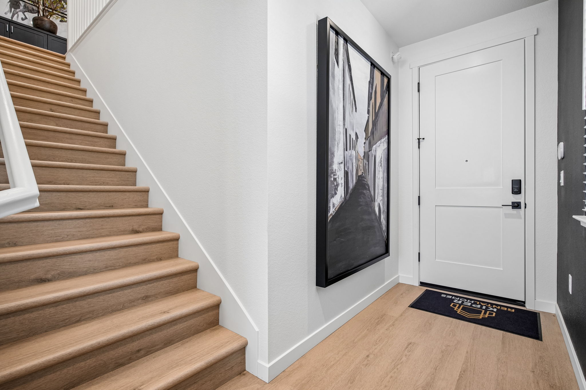 Stairs and view of front door