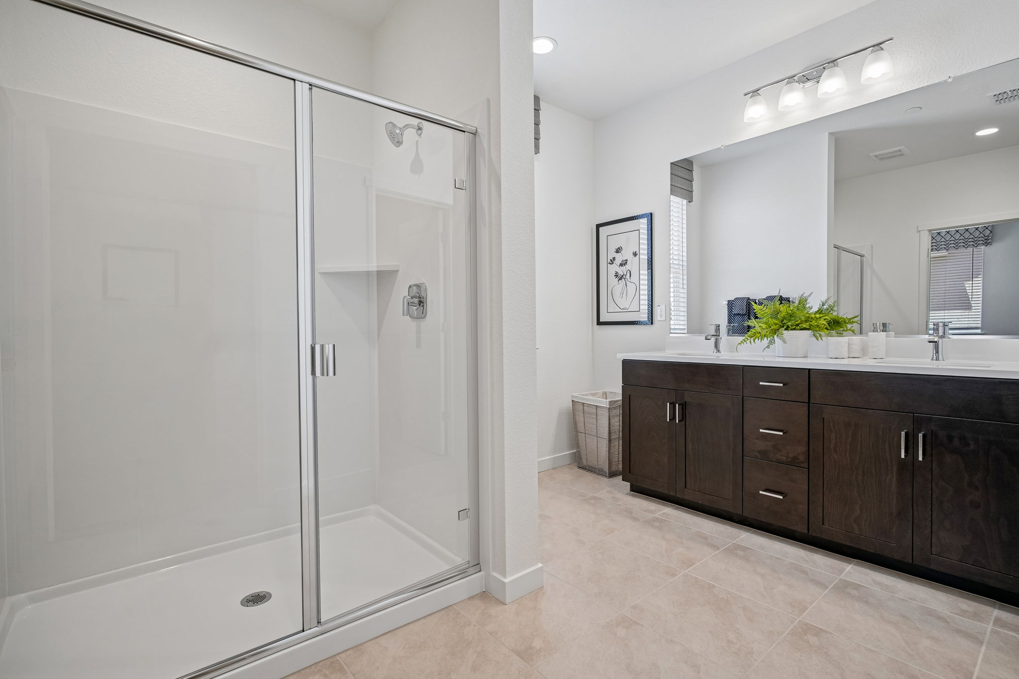 Bathroom with brown vanity, mirror, and shower