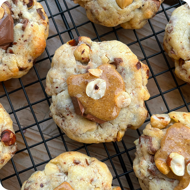 Burger with fried fries on black plate with sauce on the side