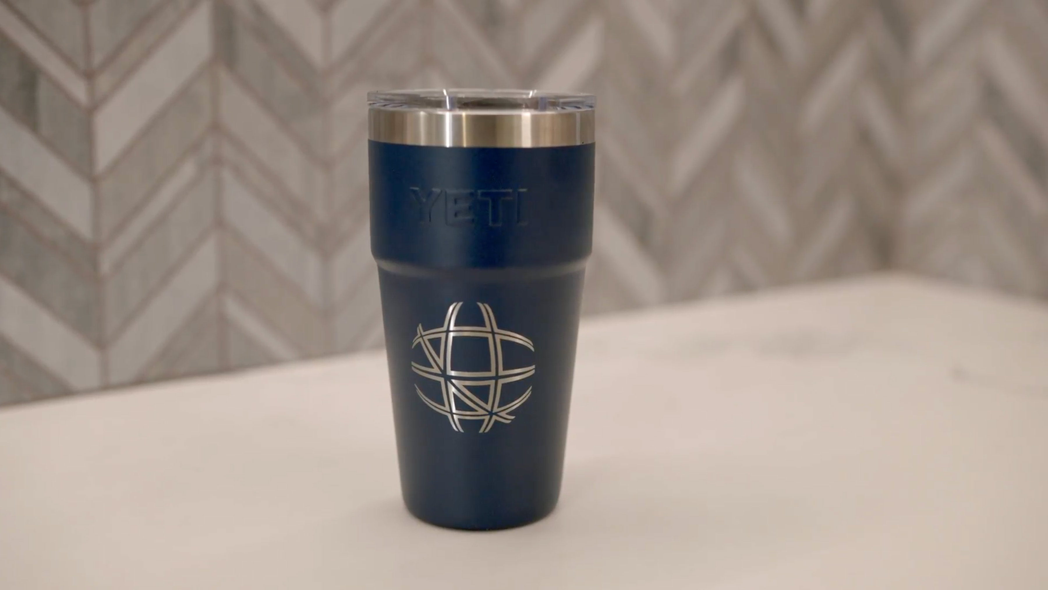 TSCM logomark on a dark blue Yeti mug