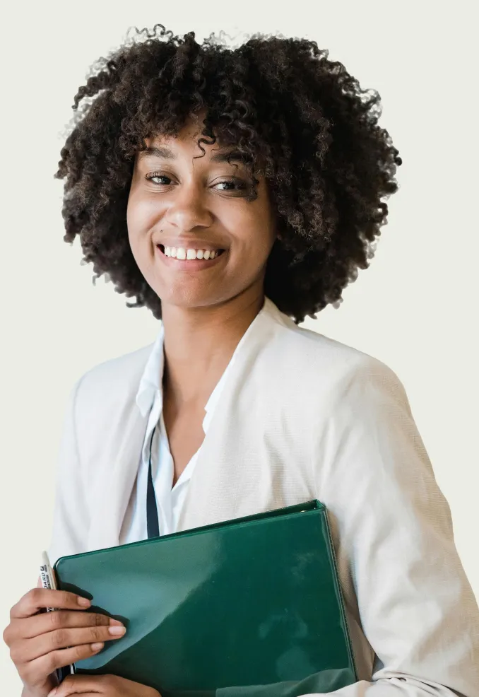 Smiling woman with curly hair wearing a white blazer and holding a green folder.