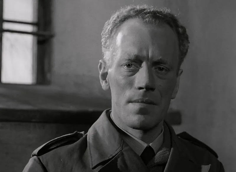 Black and white portrait of a serious man in military attire