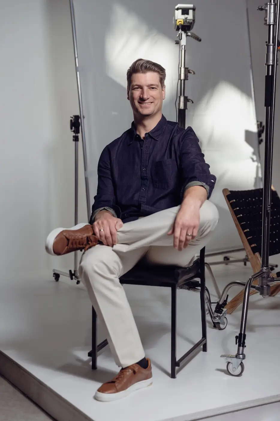 Brendan Creaser, owner of Bohemia Bay Studio, sitting in the studio