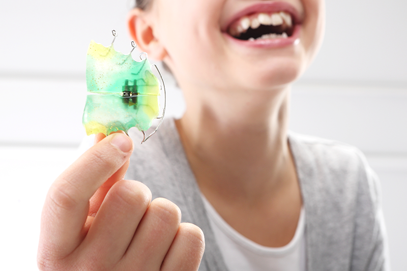 Clear removable orthodontic retainer on a dental model at Ogden Orthodontics