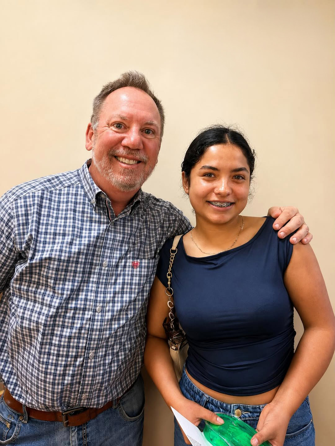 Dr. Robert Ogden smiling with a teenage braces patient at Ogden Orthodontics