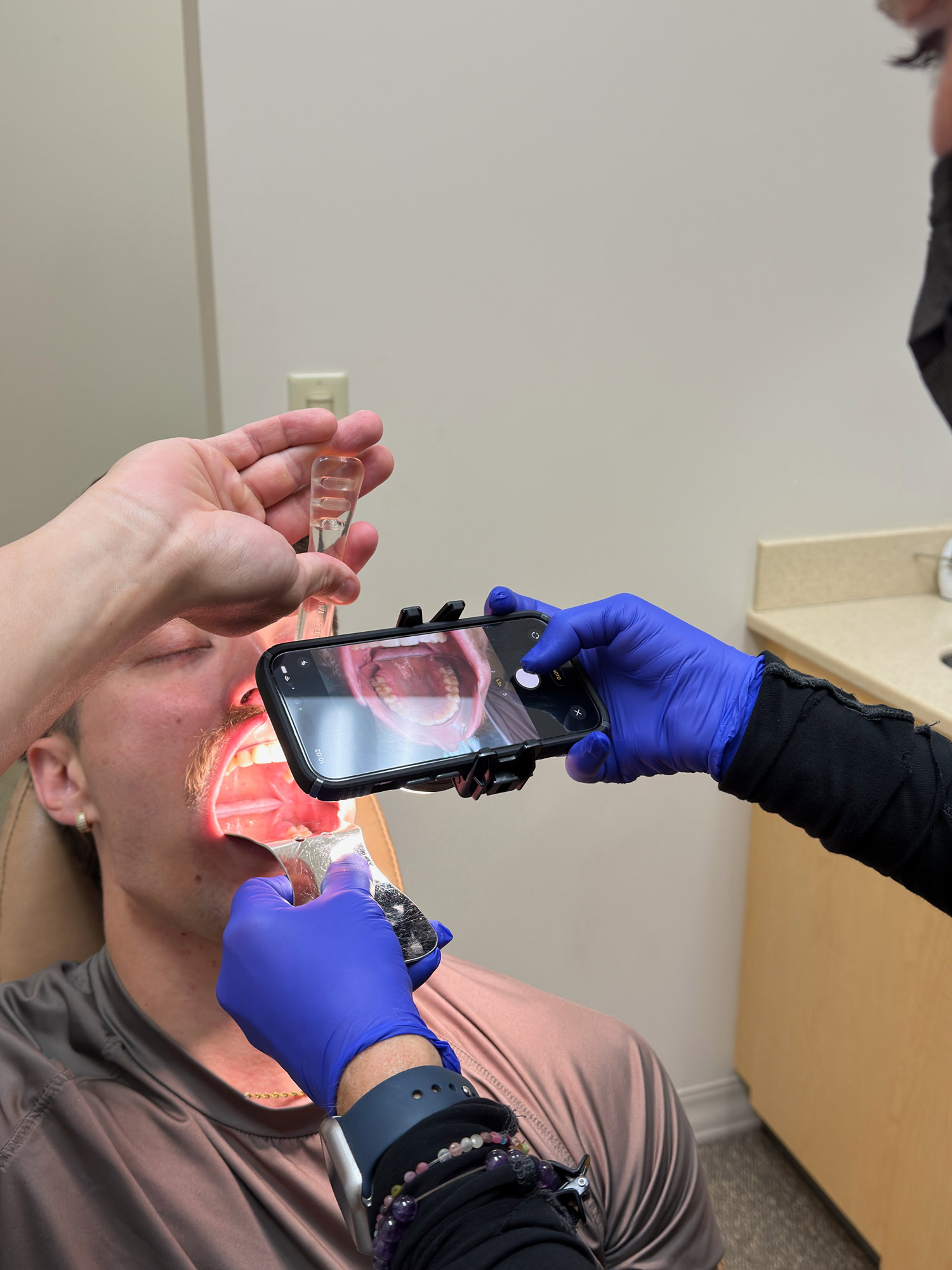Ogden Orthodontics team member taking intraoral photographs of a new Invisalign patient at the Mount Dora office