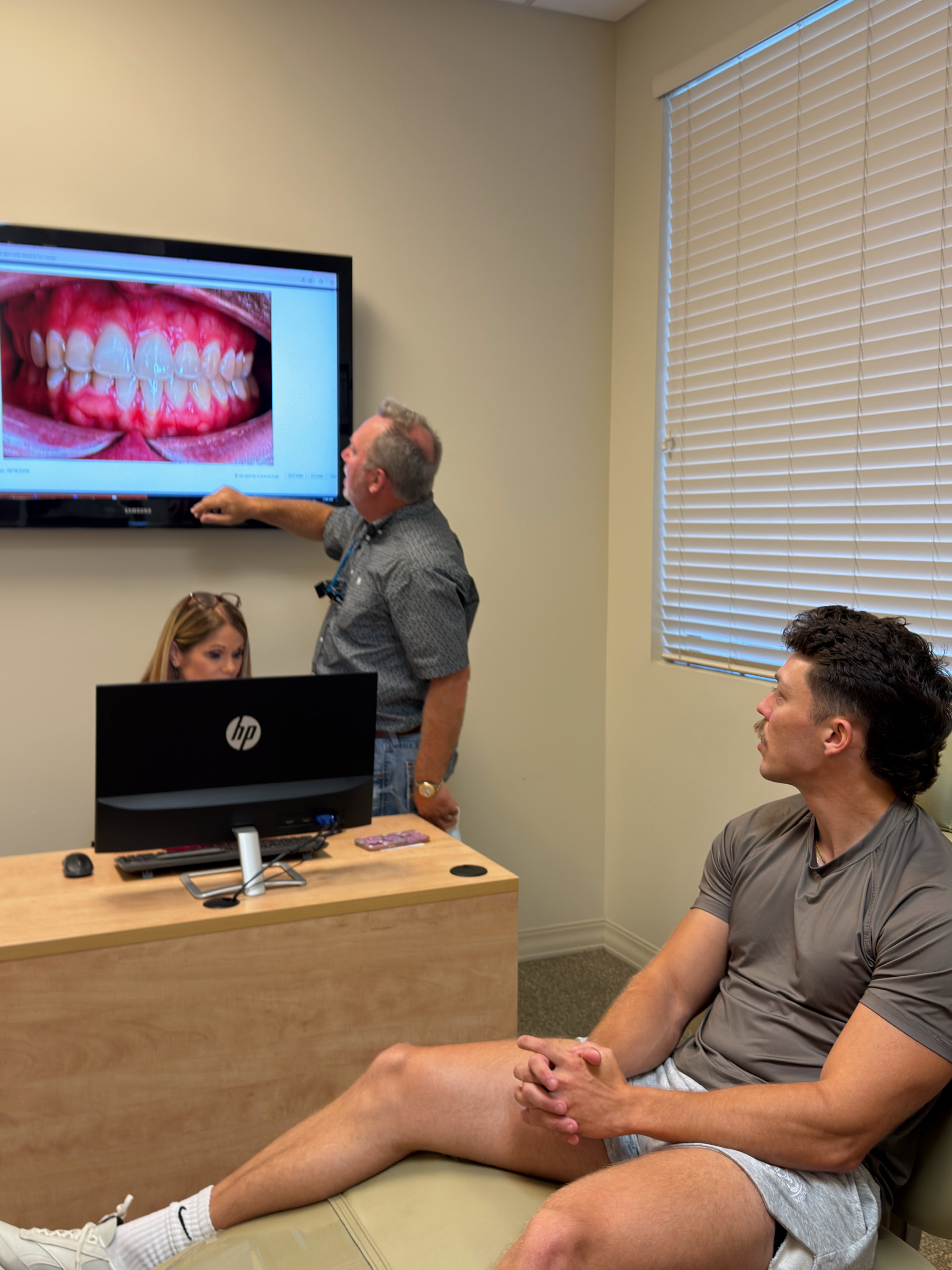 Dr. Robert Ogden going over a patient's treatment plan on screen at the Mount Dora office