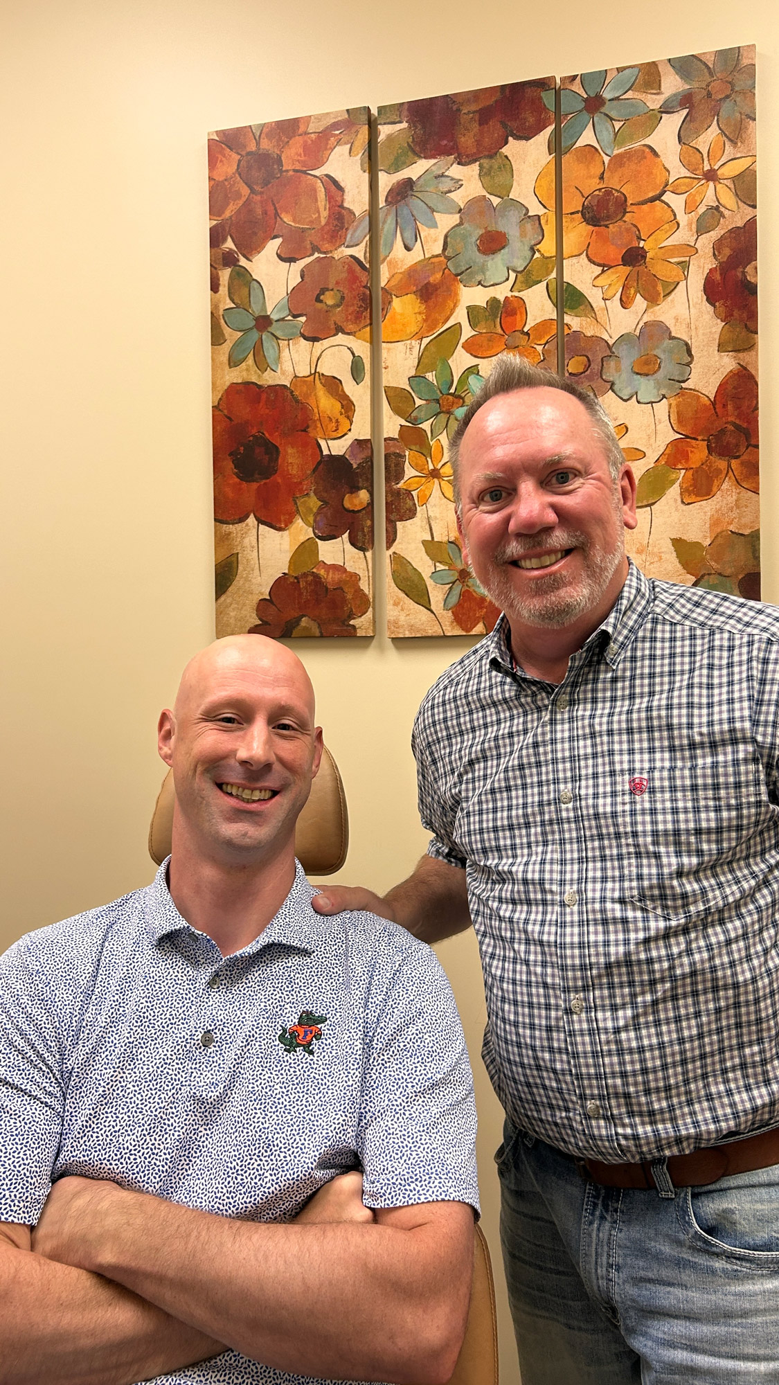 Dr. Robert Ogden, orthodontist at Ogden Orthodontics, standing at right