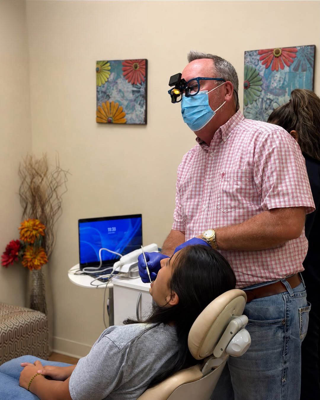 Dr. Robert Ogden examining an Invisalign patient at Ogden Orthodontics