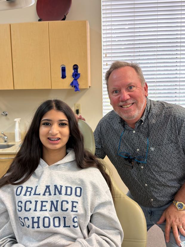 Dr. Robert Ogden with a teen patient on the day her braces were placed