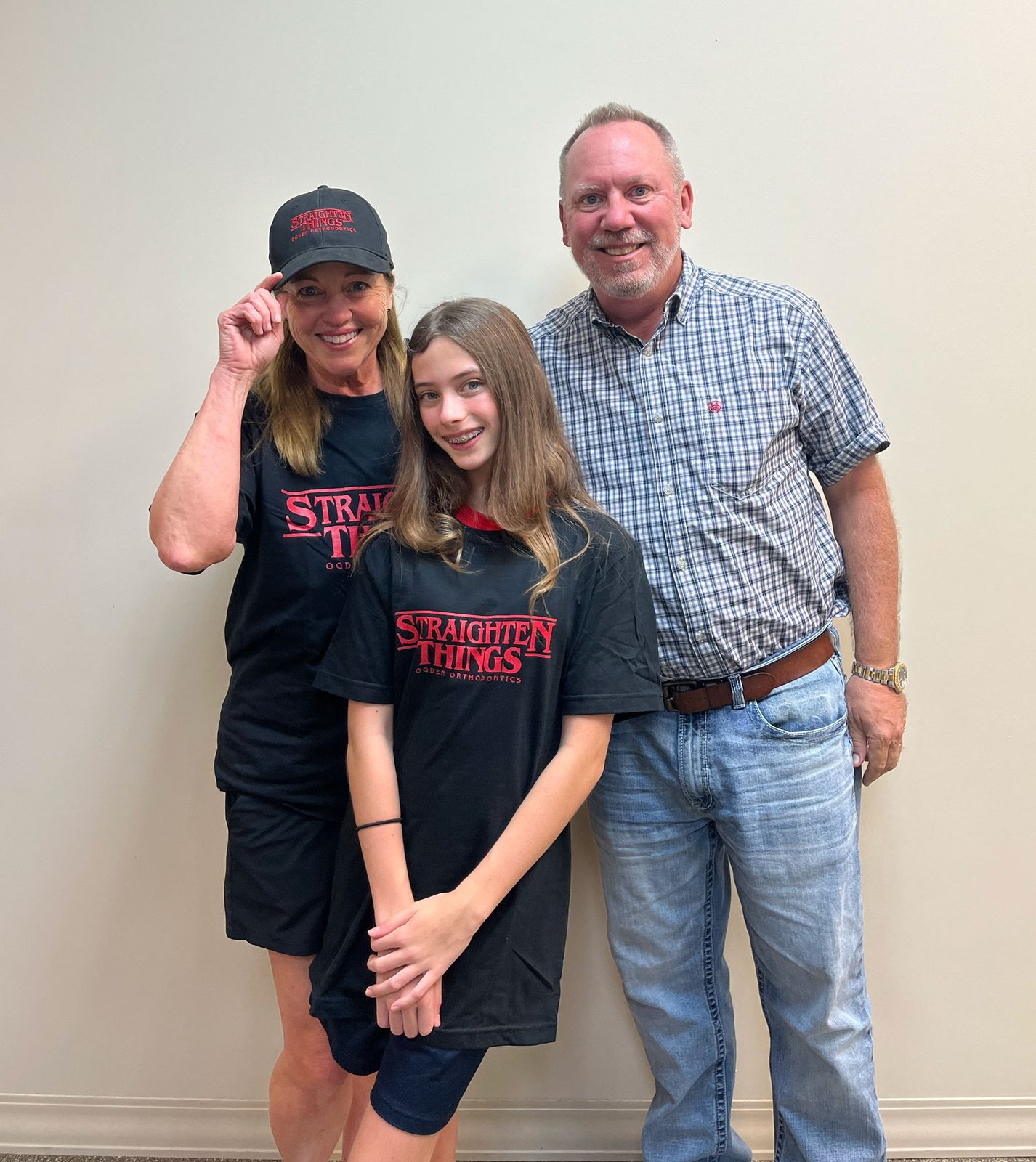 Dr. Robert Ogden with a young braces patient and her mother at Ogden Orthodontics