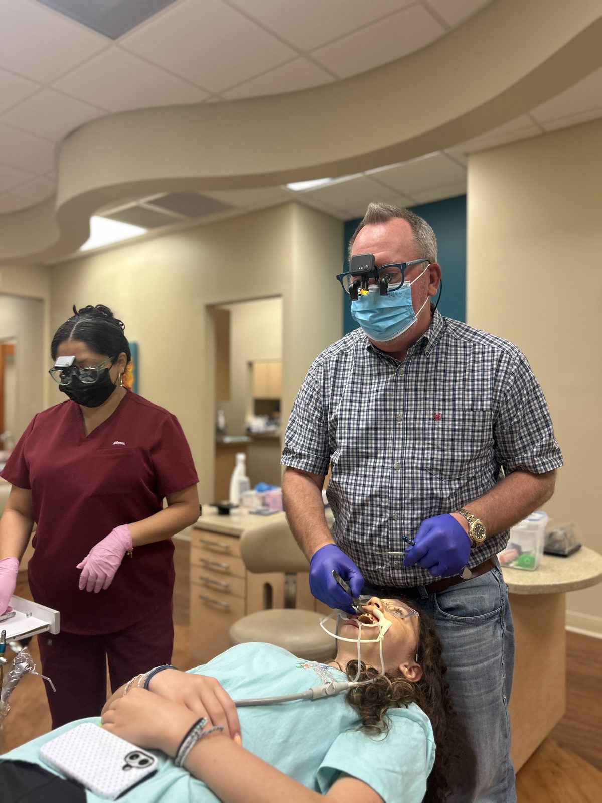 Dr. Robert Ogden and a clinical assistant working on a patient during a braces appointment at Ogden Orthodontics