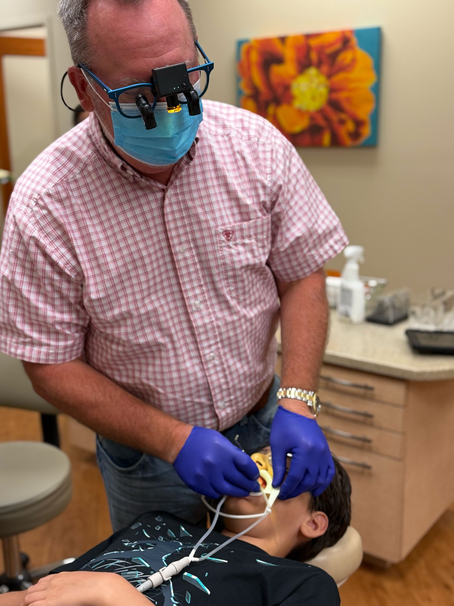 Dr. Robert Ogden placing braces on a young patient at Ogden Orthodontics