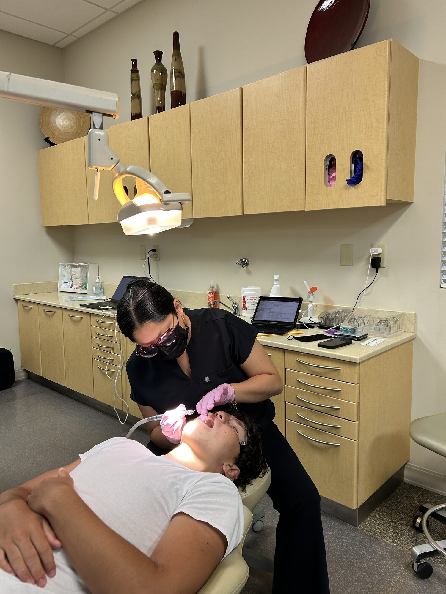 Teenage patient having braces adjusted in the treatment chair at Ogden Orthodontics