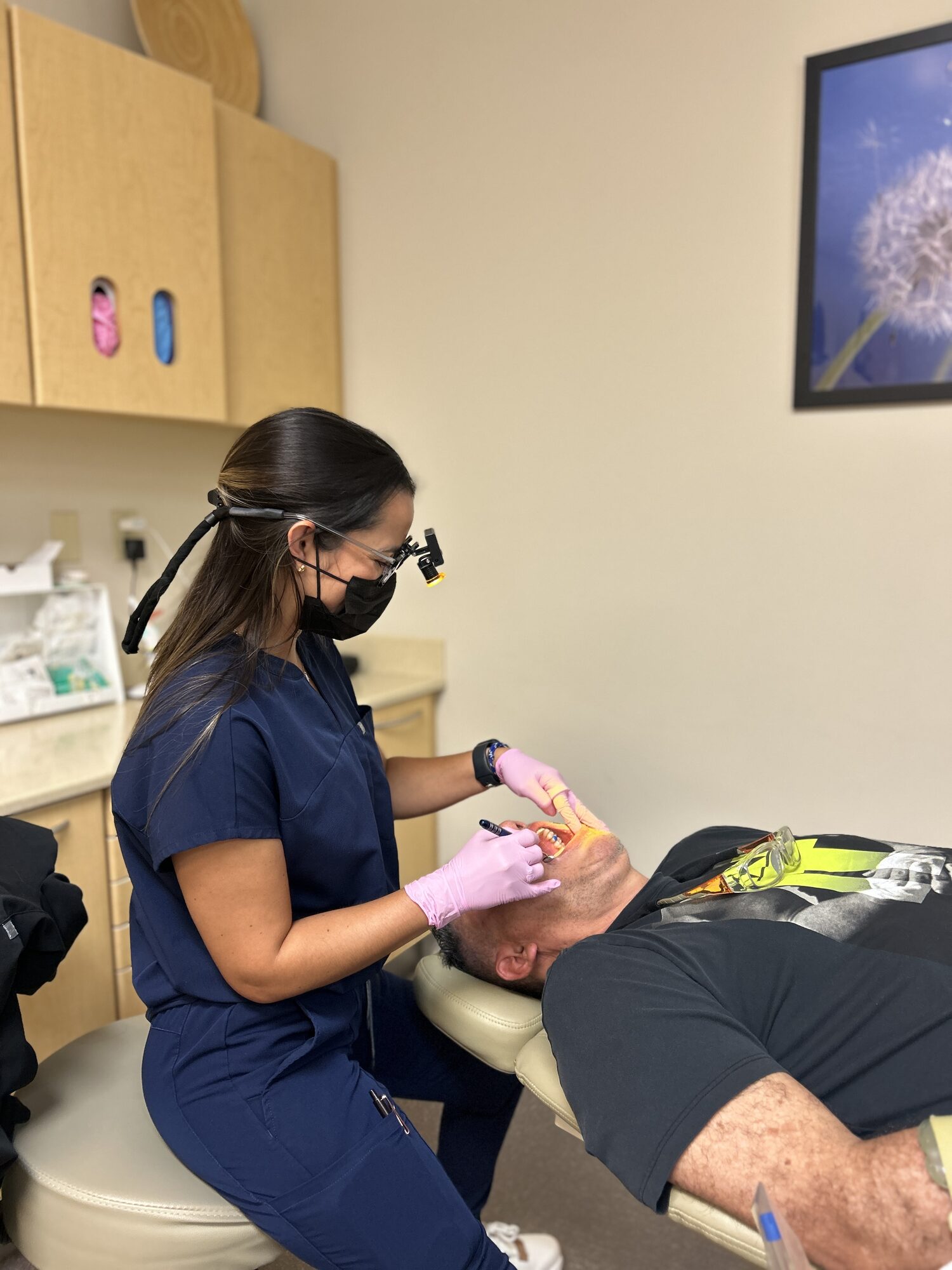 Adult patient having his braces checked chairside at Ogden Orthodontics