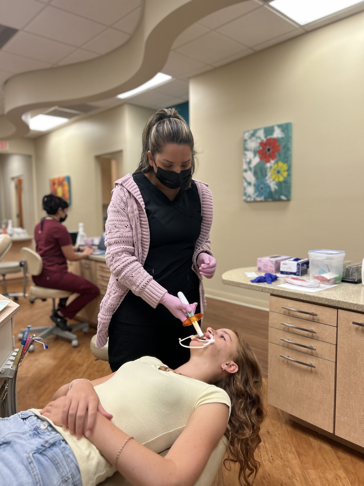 Ogden Orthodontics assistant curing newly bonded brackets with a curing light