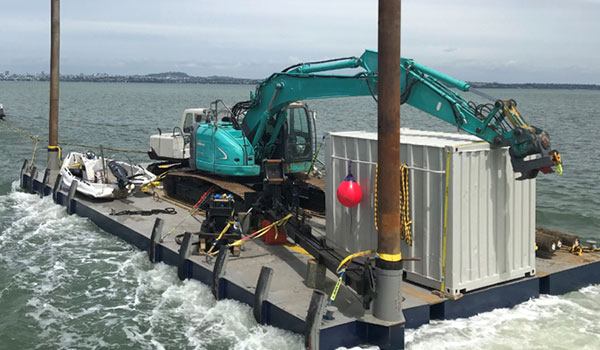 The BB2 piling barge alongside a marina