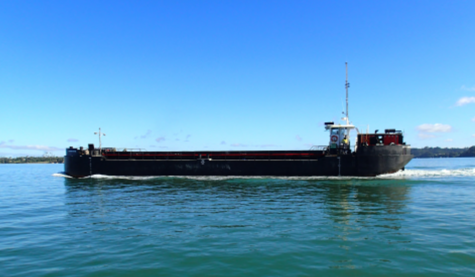 Self-propelled split hopper barge carrying dredged spoil