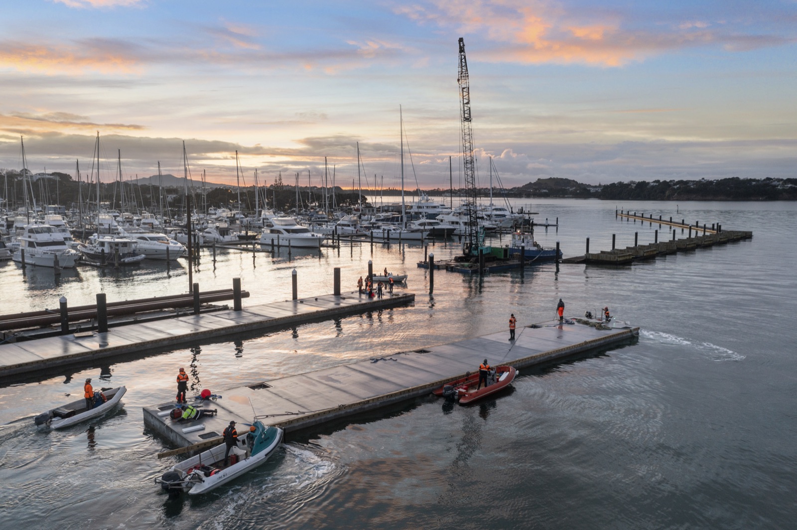 Empire Marine pontoons and workboats at a marina at dusk