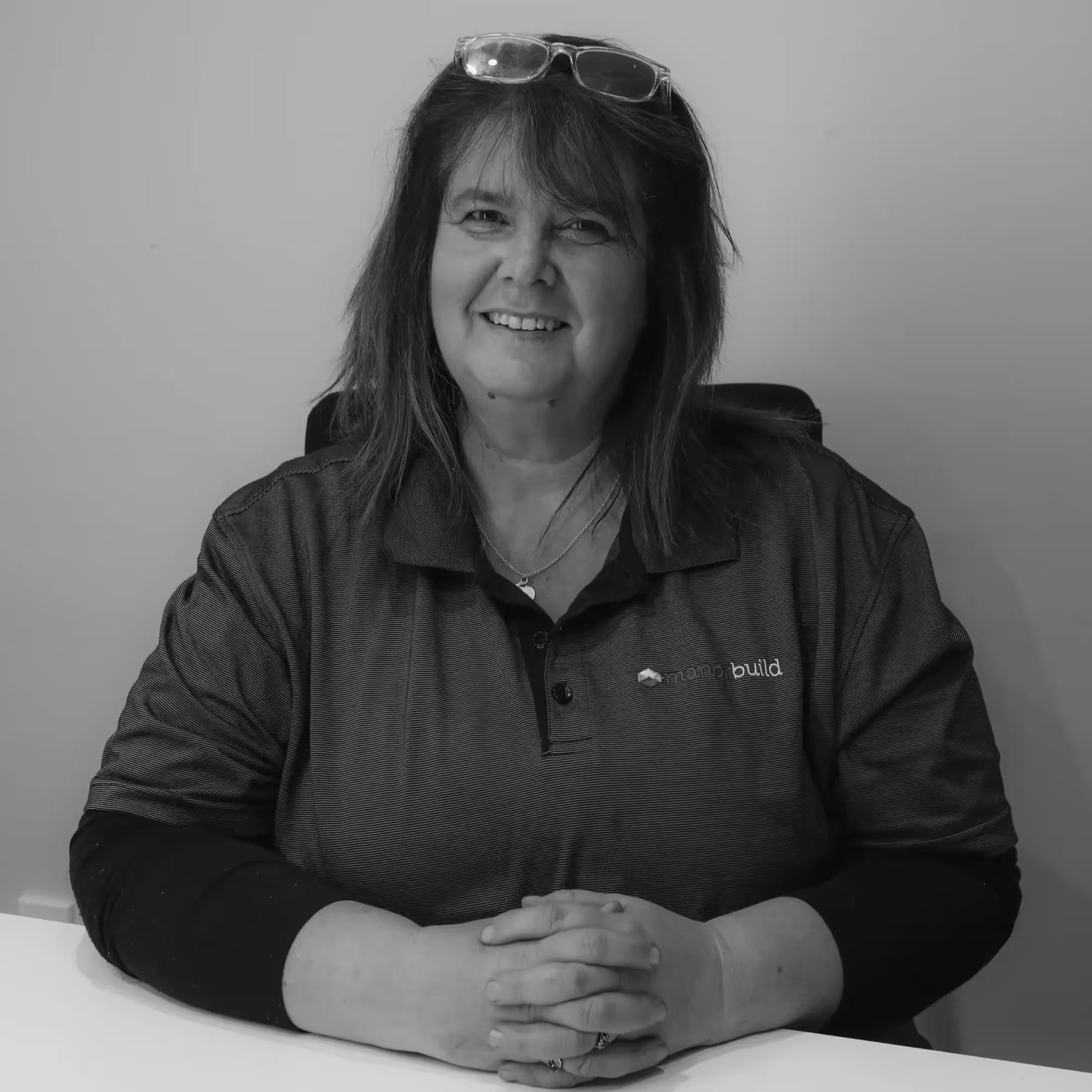 A black and white photo of a lady sitting in a chair