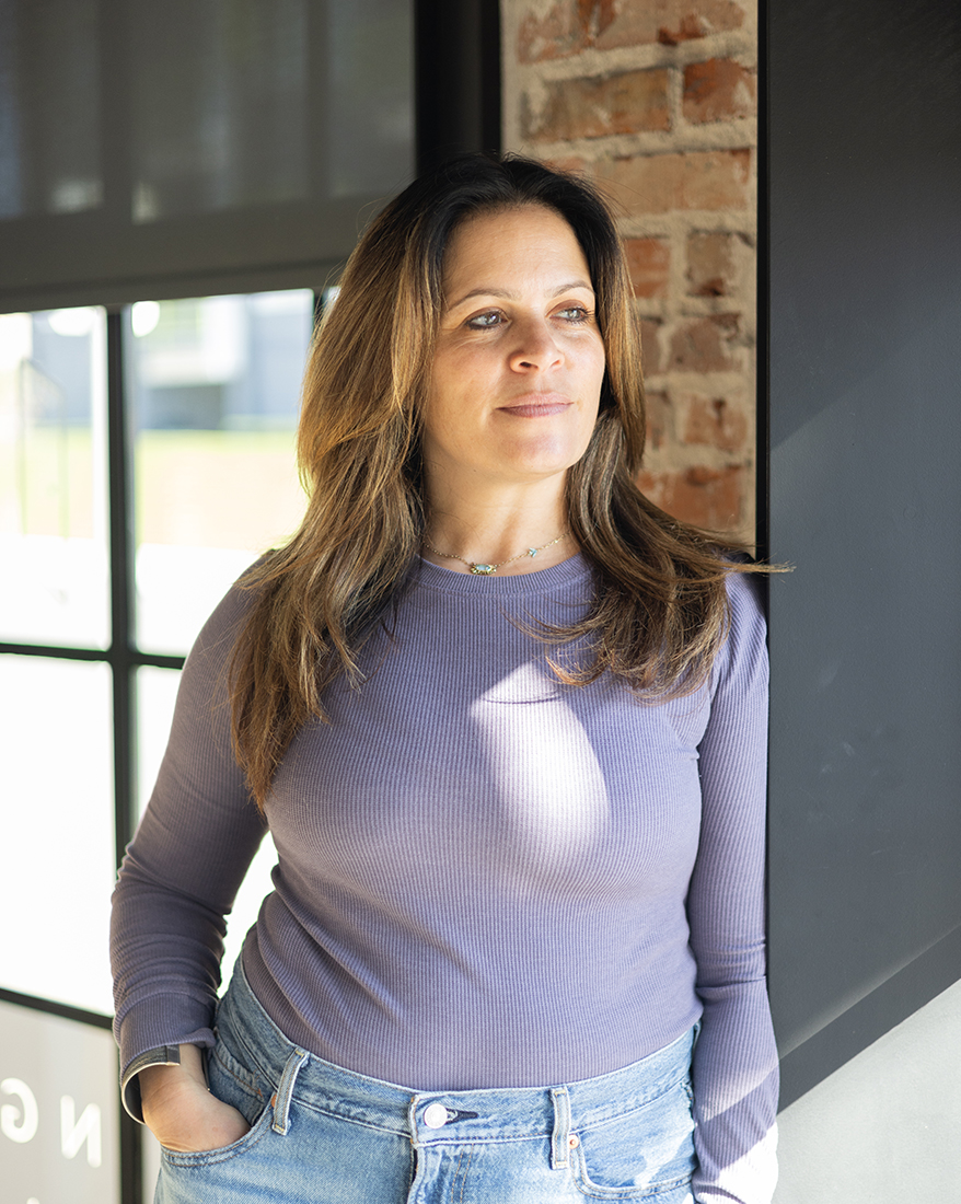 Melissa Silverstein standing by a window in a professional workspace