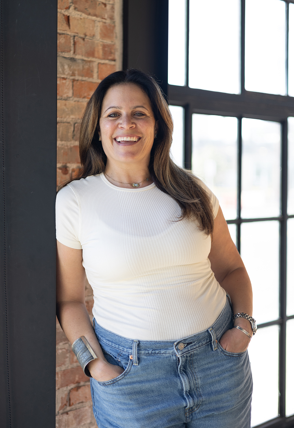 Melissa Silverstein standing near a window in a professional setting