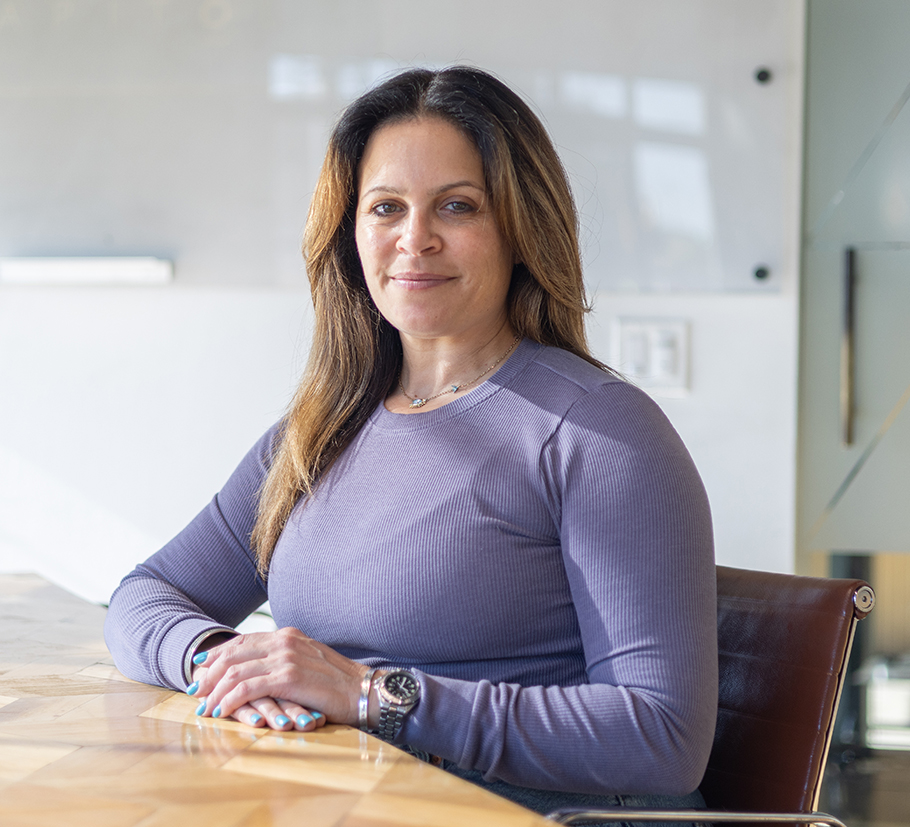 Melissa Silverstein seated at a table in a professional setting