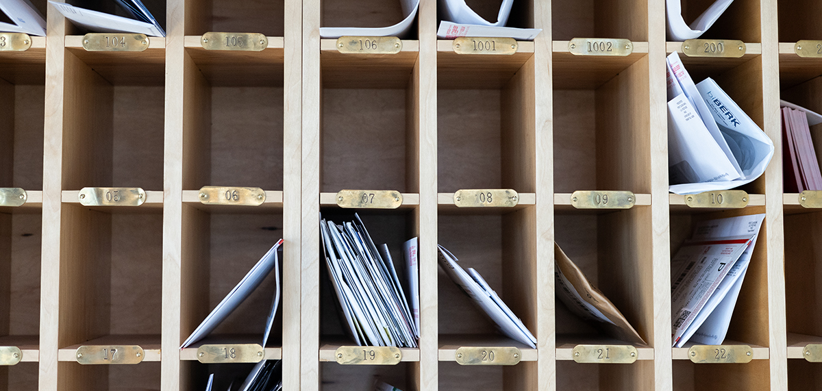 Wall of mailboxes inside a shared building interior