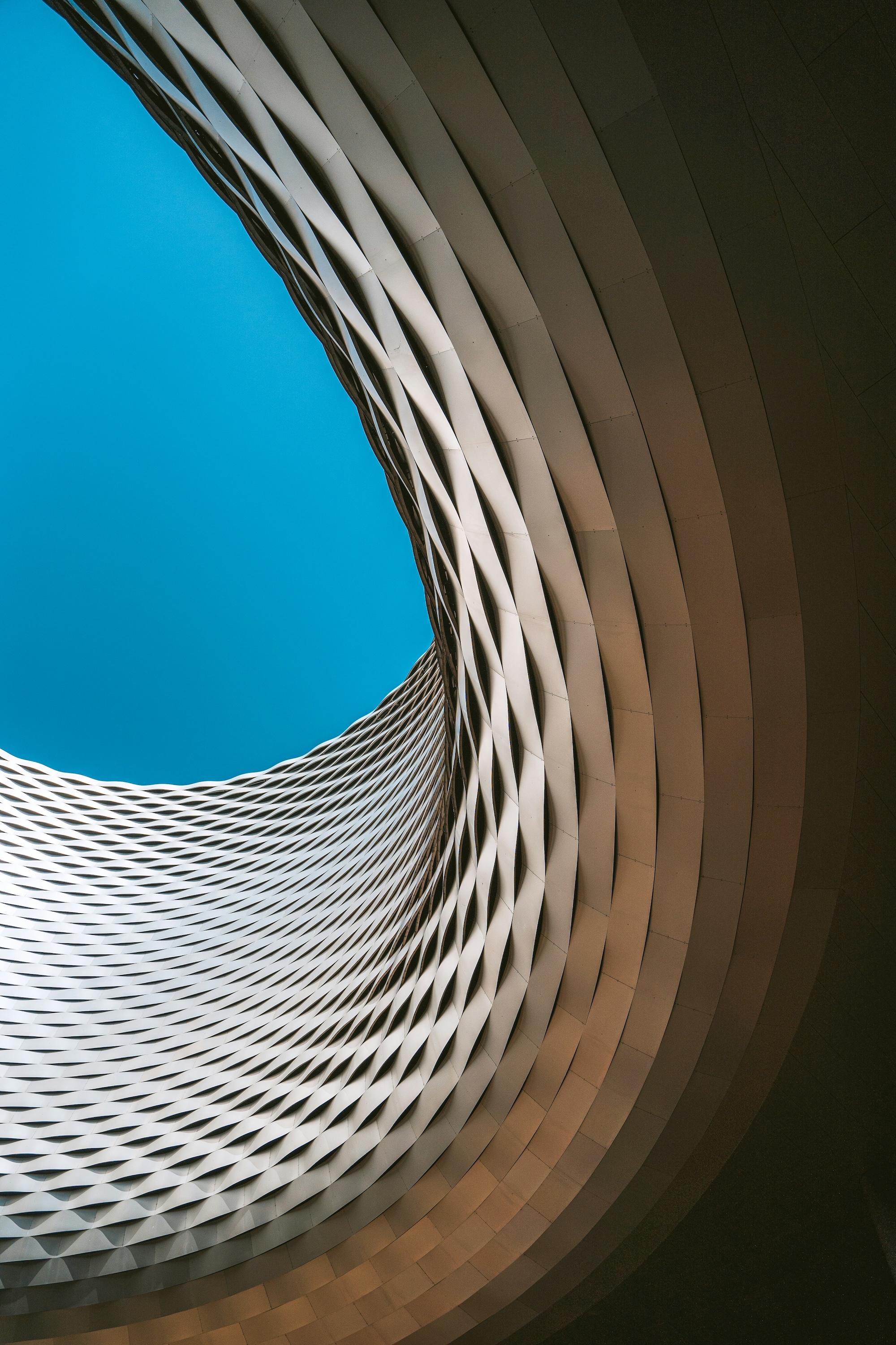 Abstract modern architectural detail against a cloudless blue sky