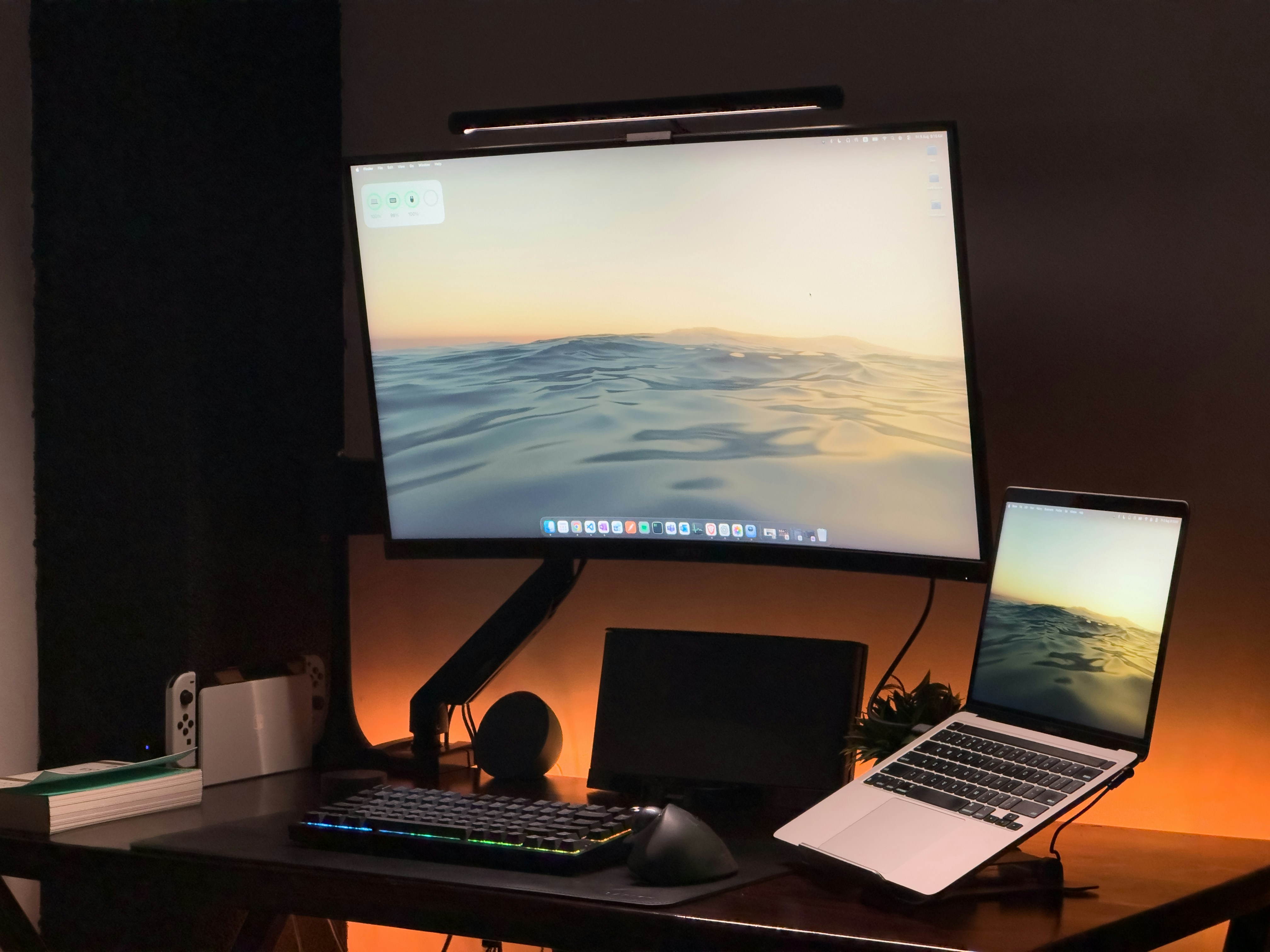A computer workstation with a curved screen in a dark room