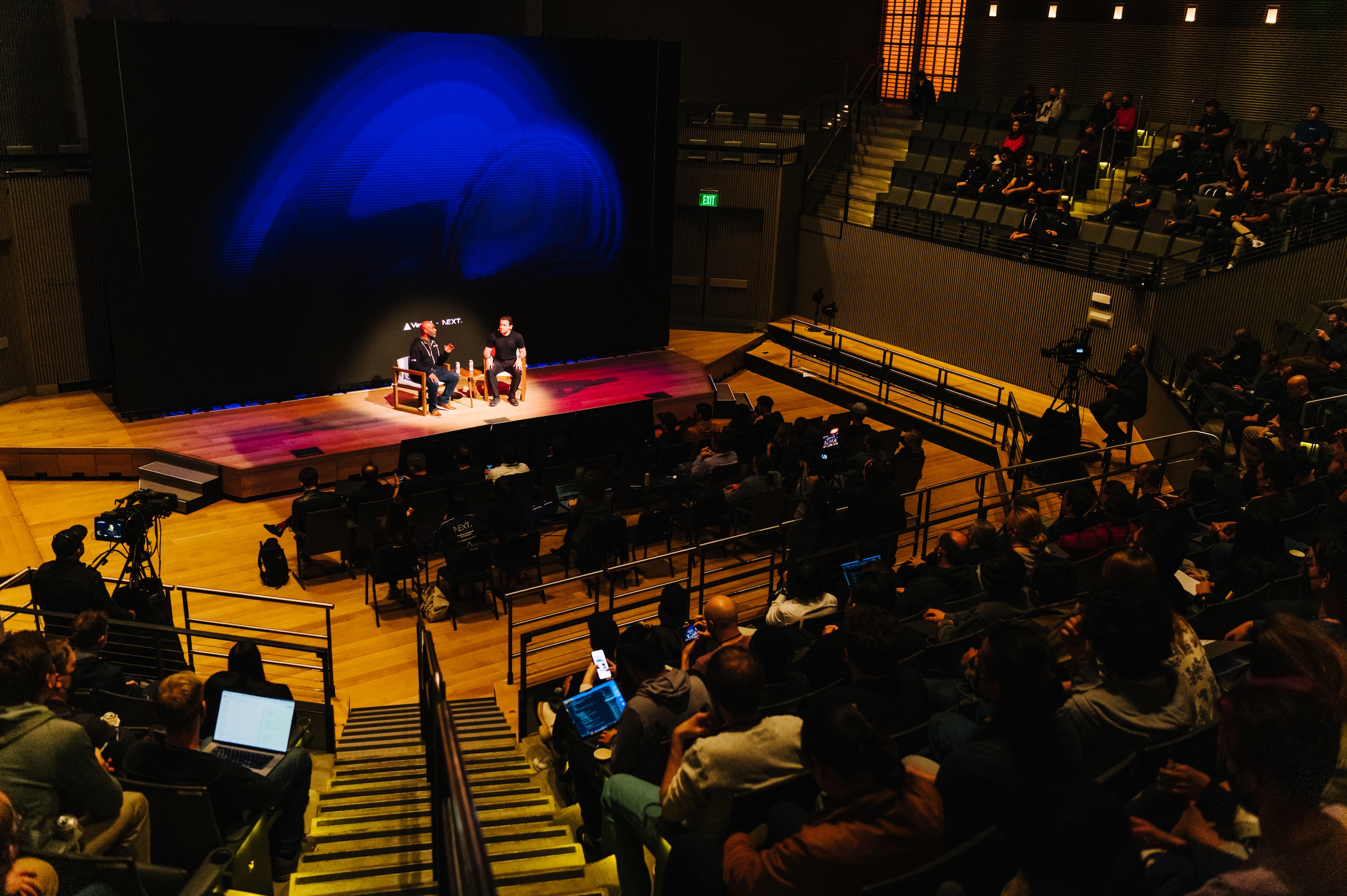 Two men talking on stage at a technology conference
