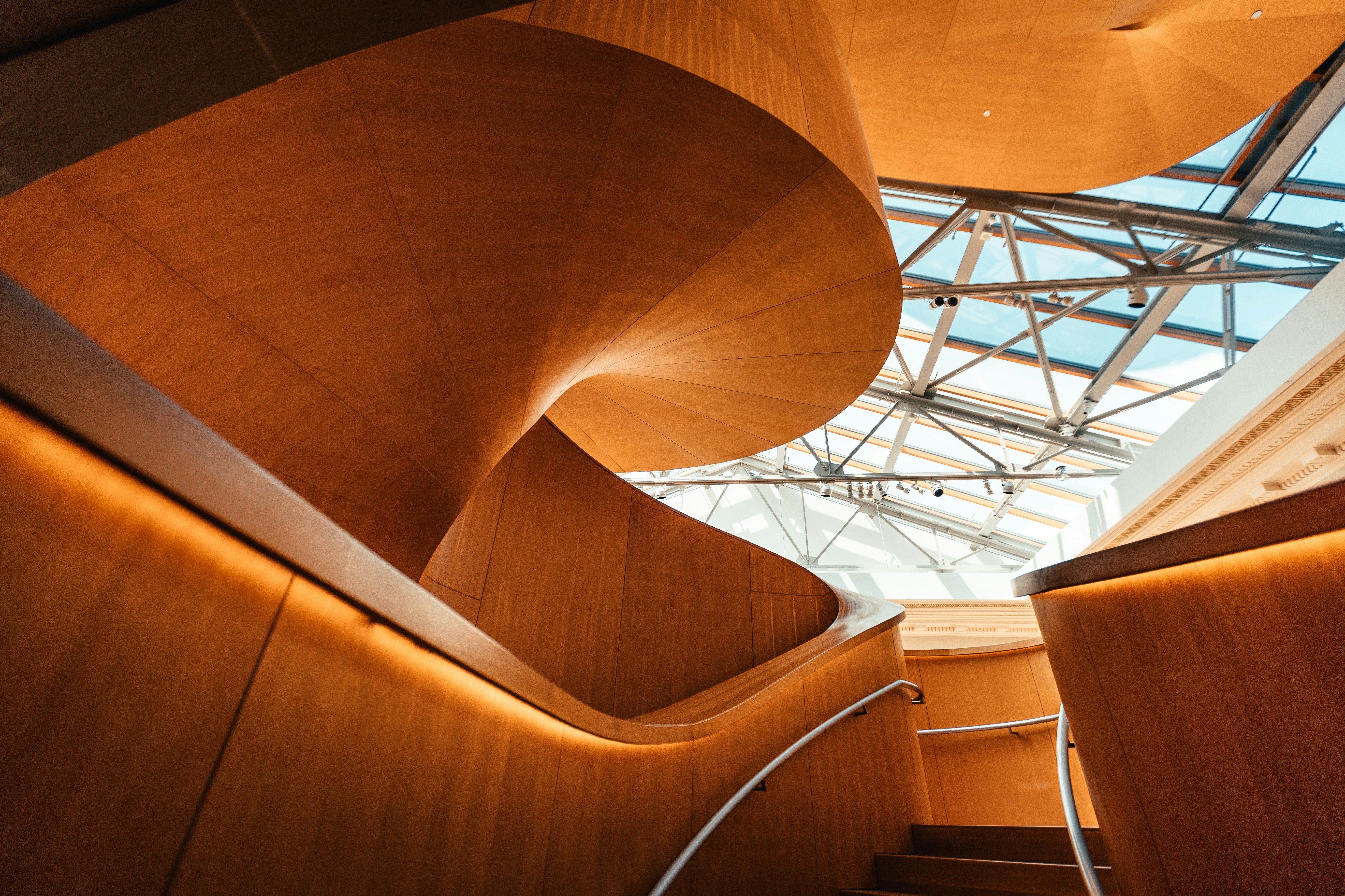 A detail of an curved wooden staircase in a modern building 