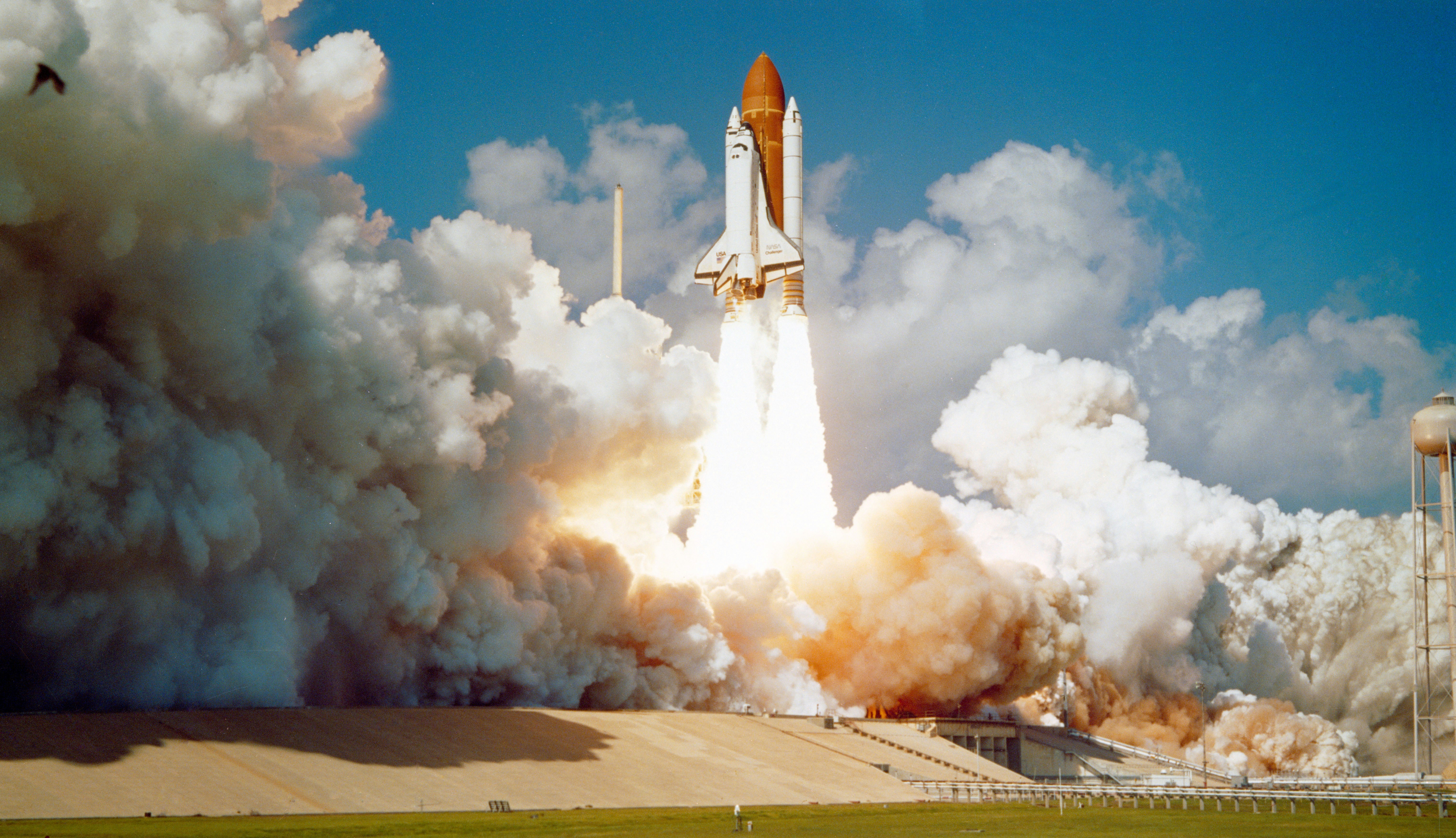 A NASA Challenger rocket launch with plumes of exhaust