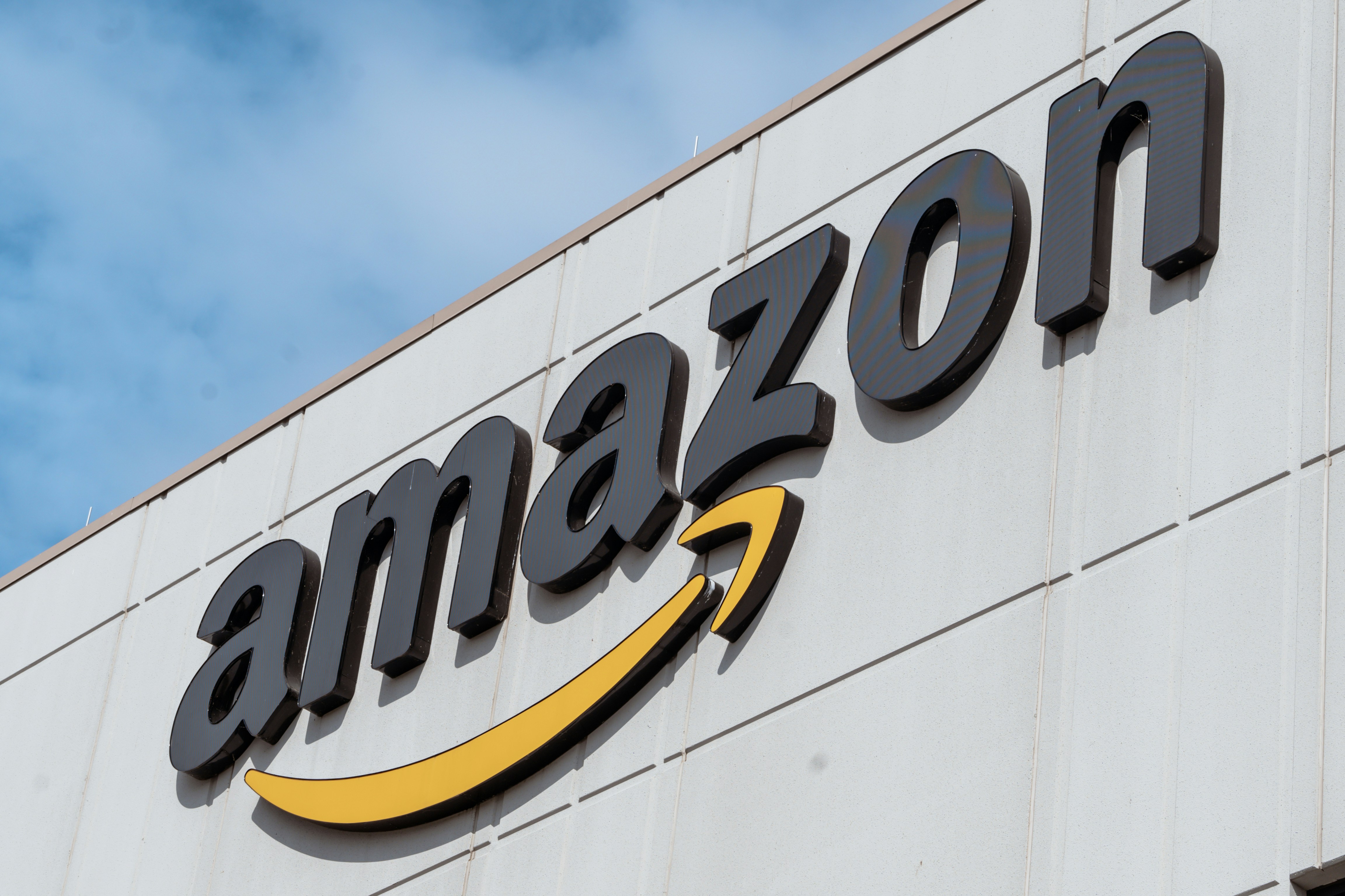 A facade of an Amazon facility focussing on the logo adorning the building