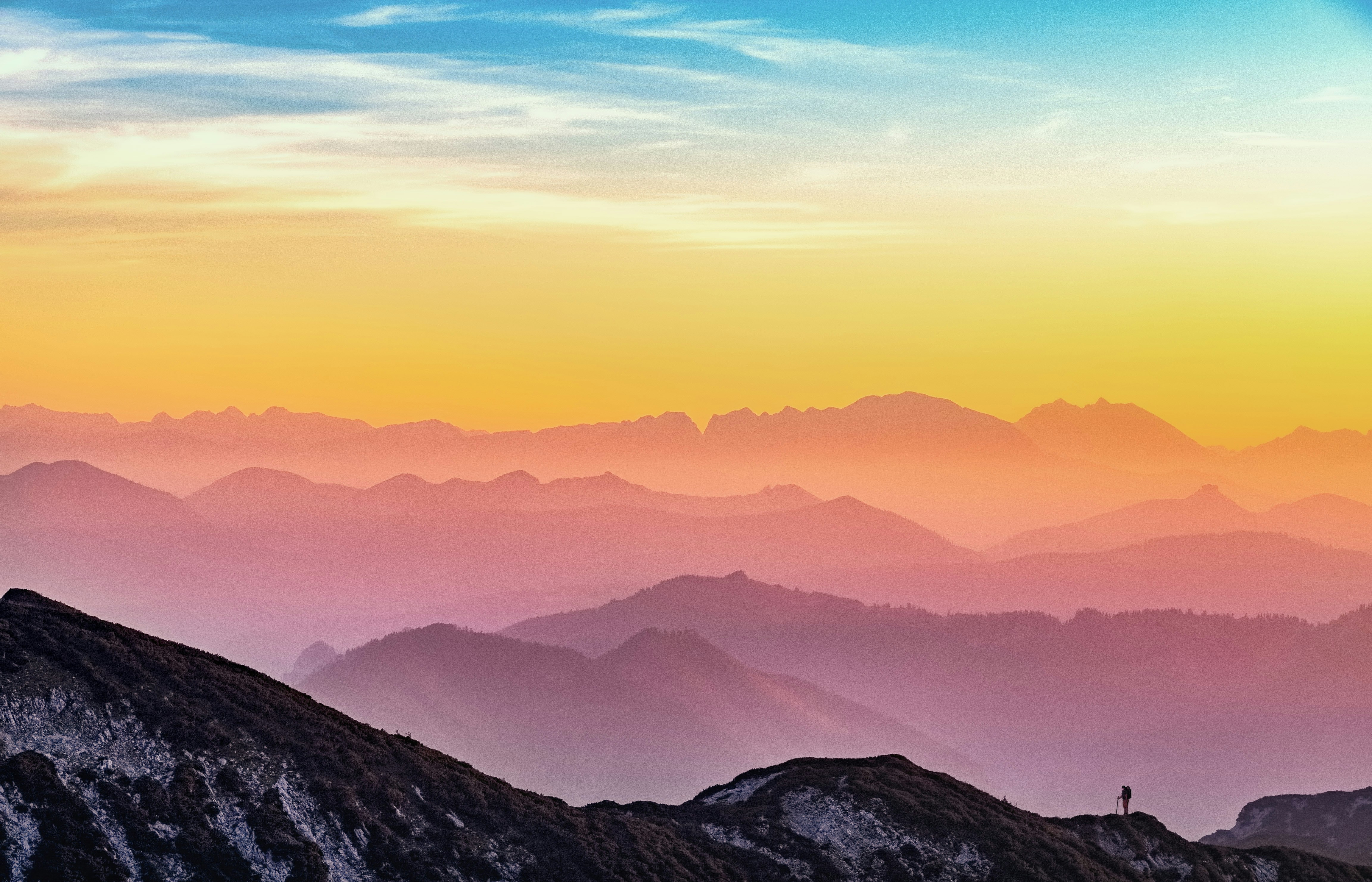 A mountainscape with vivid layering of sunset colours
