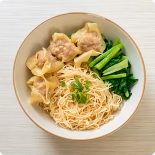 Bowl of wonton noodle soup with greens