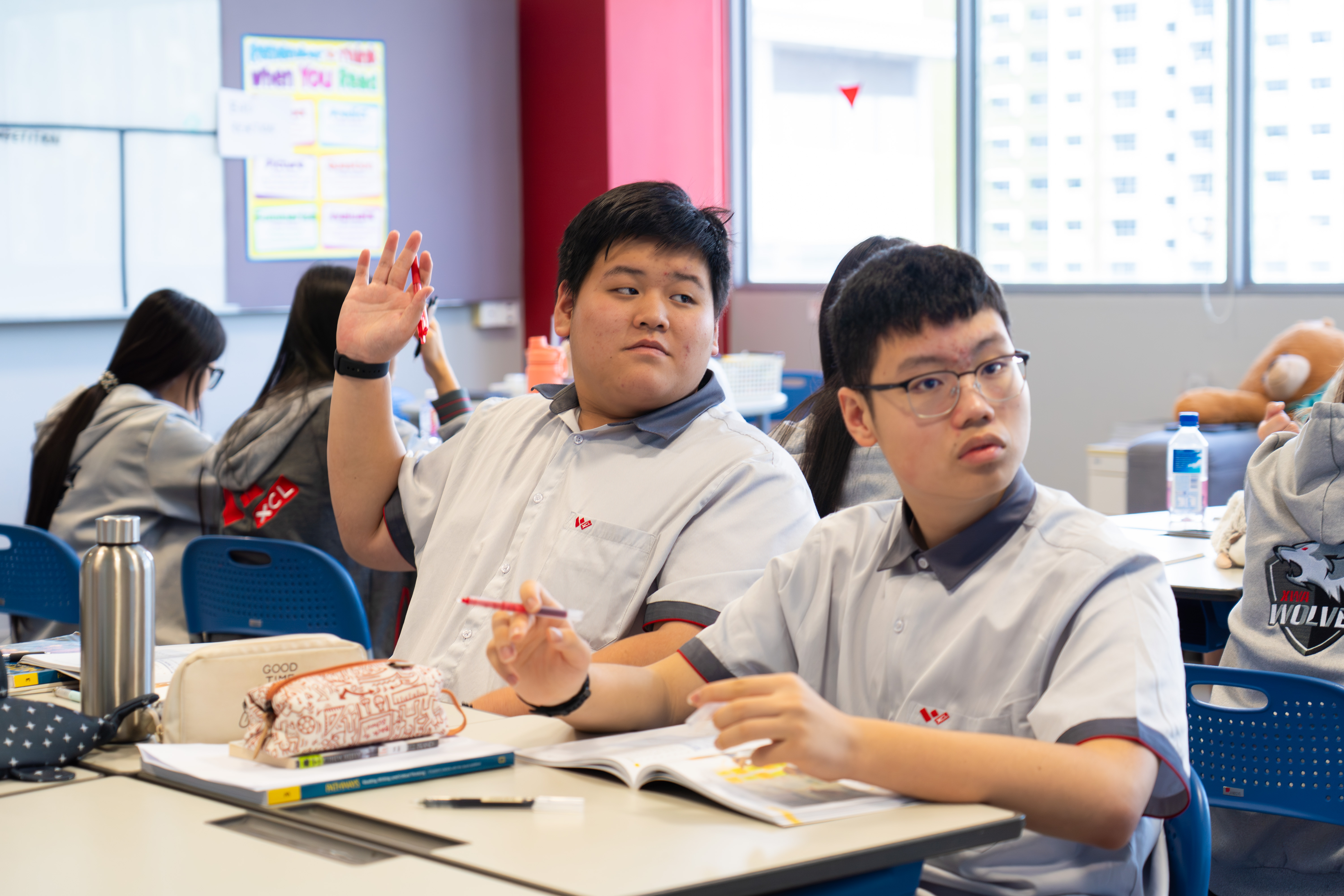 A student raising his hand in class