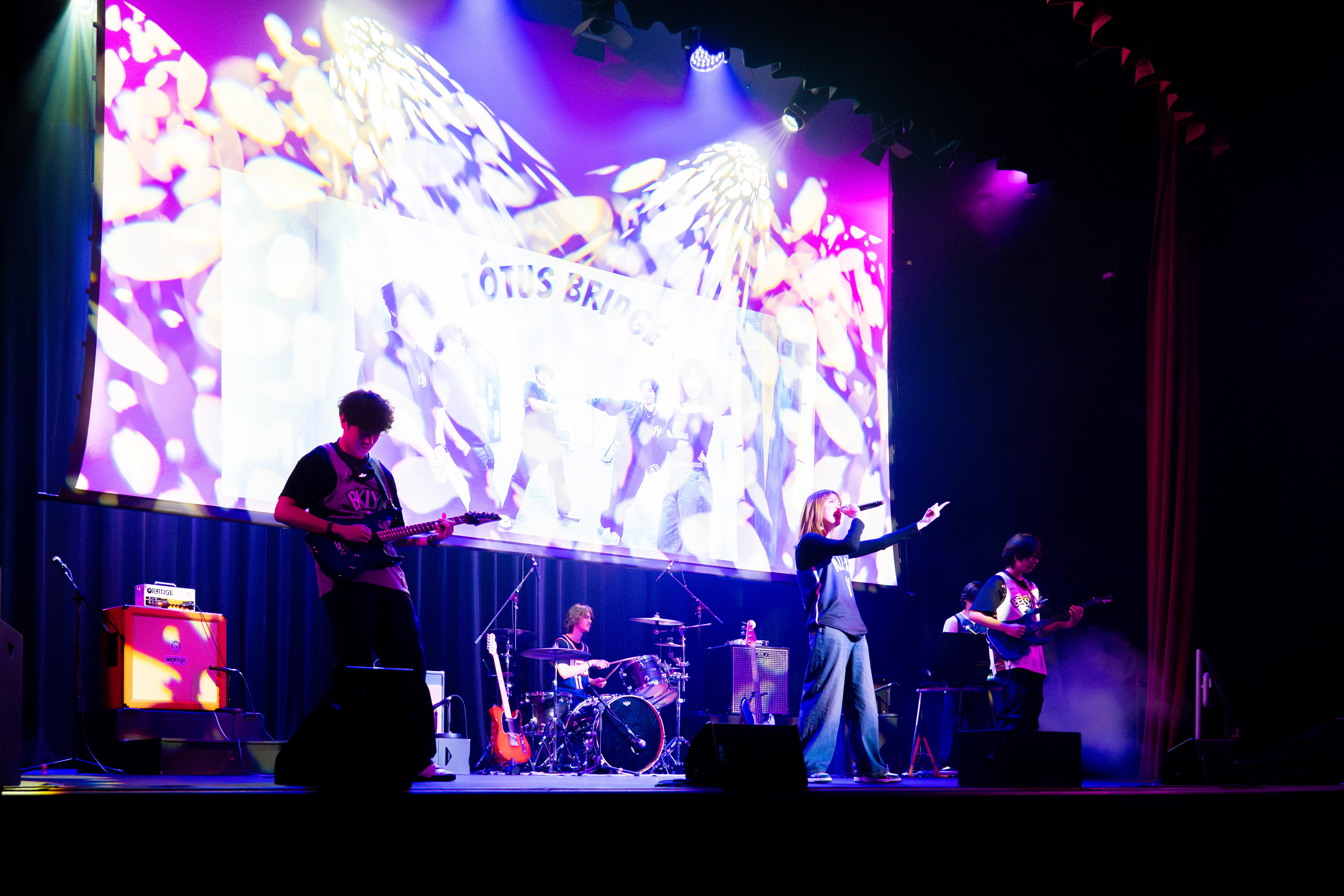 Students performing in a band on stage during Battle of the Bands