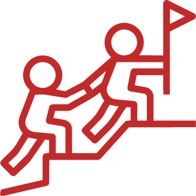 One person helping another climb a mountain to reach a flag at the peak