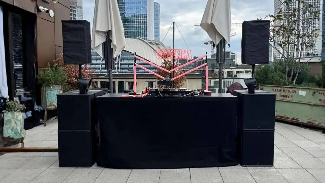 Seeburg Konzert PA Stack im Freien mit zwei Lautsprecherstacks aus Subs und Tops sowie DJ-Pult.