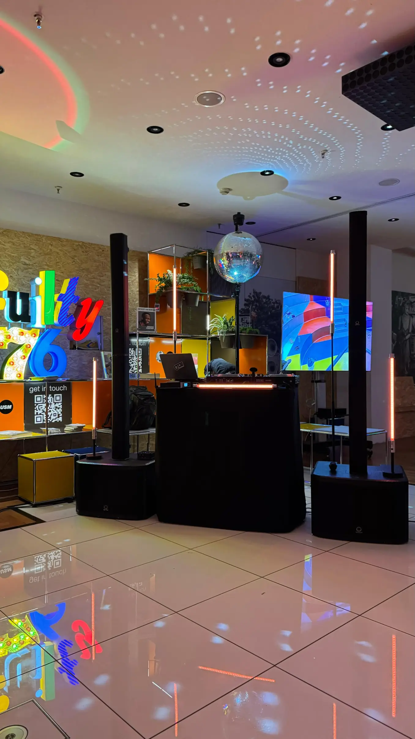 DJ-Setup mit Subwoofern, Topteilen und Discokugel in einer Lobby als PA-Anlage für Karneval mieten.