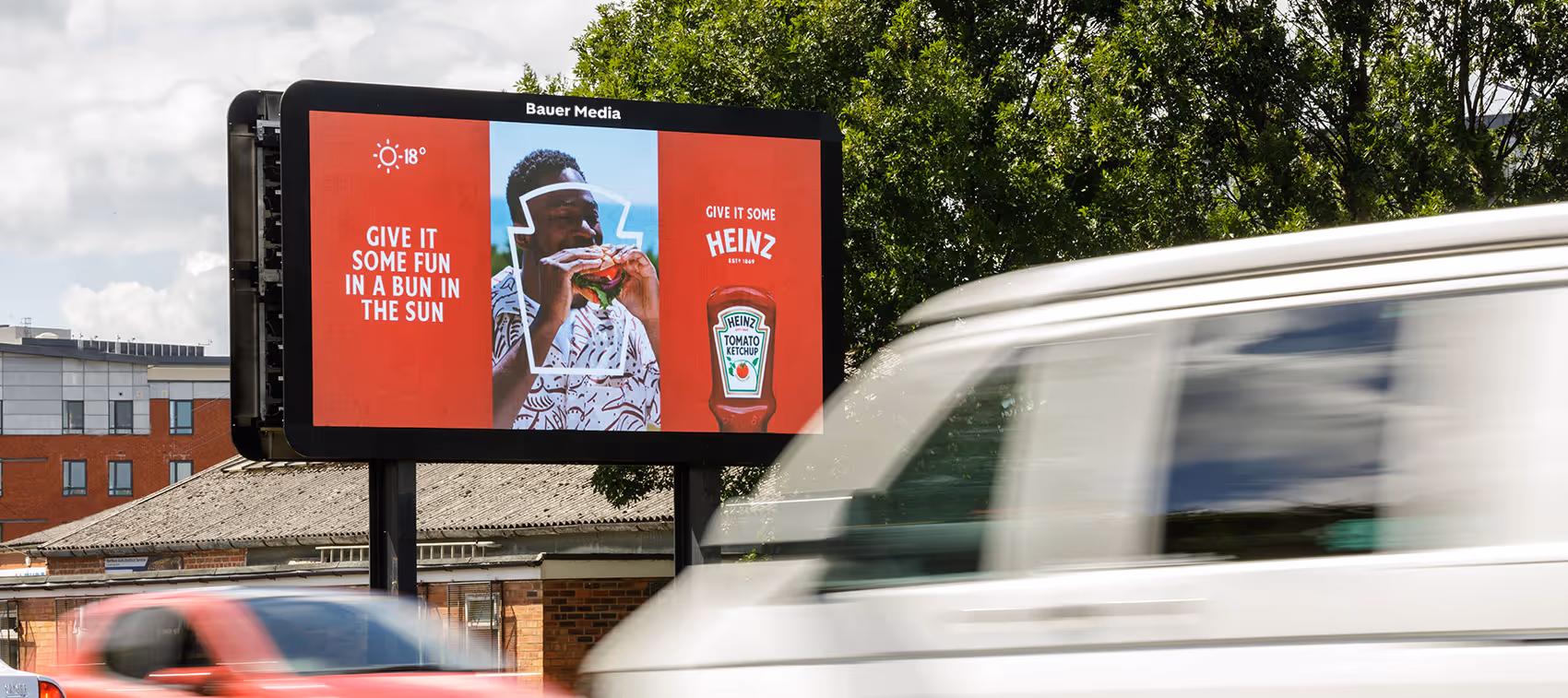 Tomato sauce advert with live temperature on a roadside digital billboard in summer