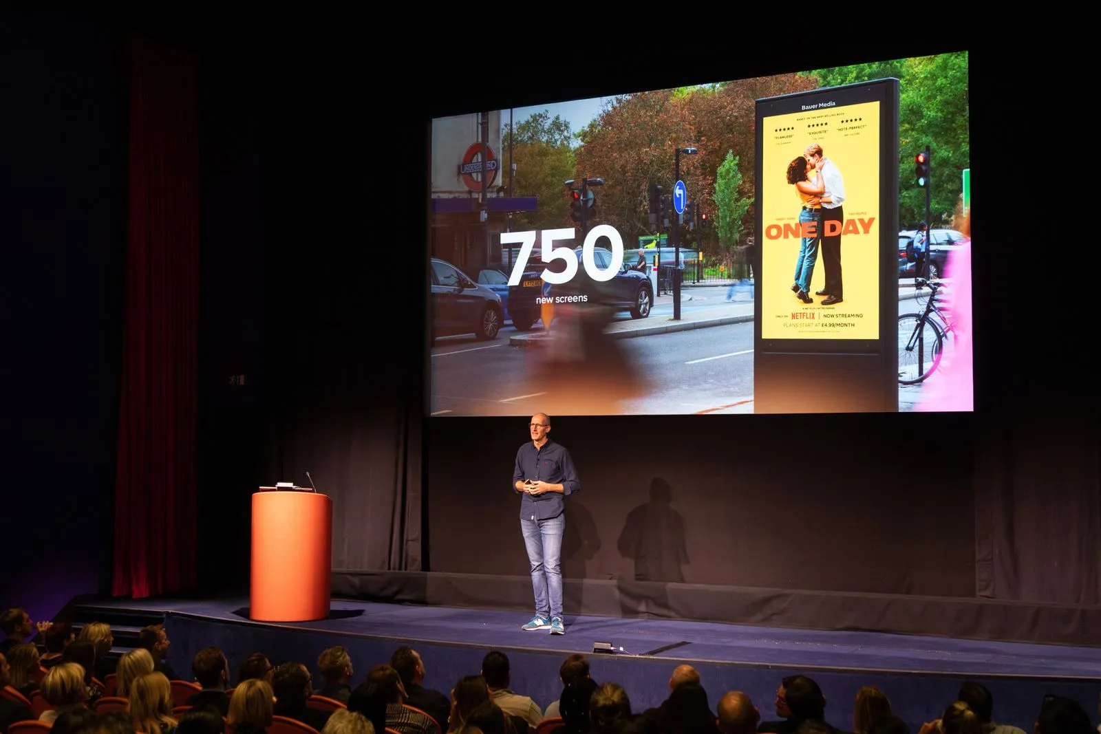 Bauer Media Outdoor's UK Managing Director Richard Bon presenting on stage at an Upfront event