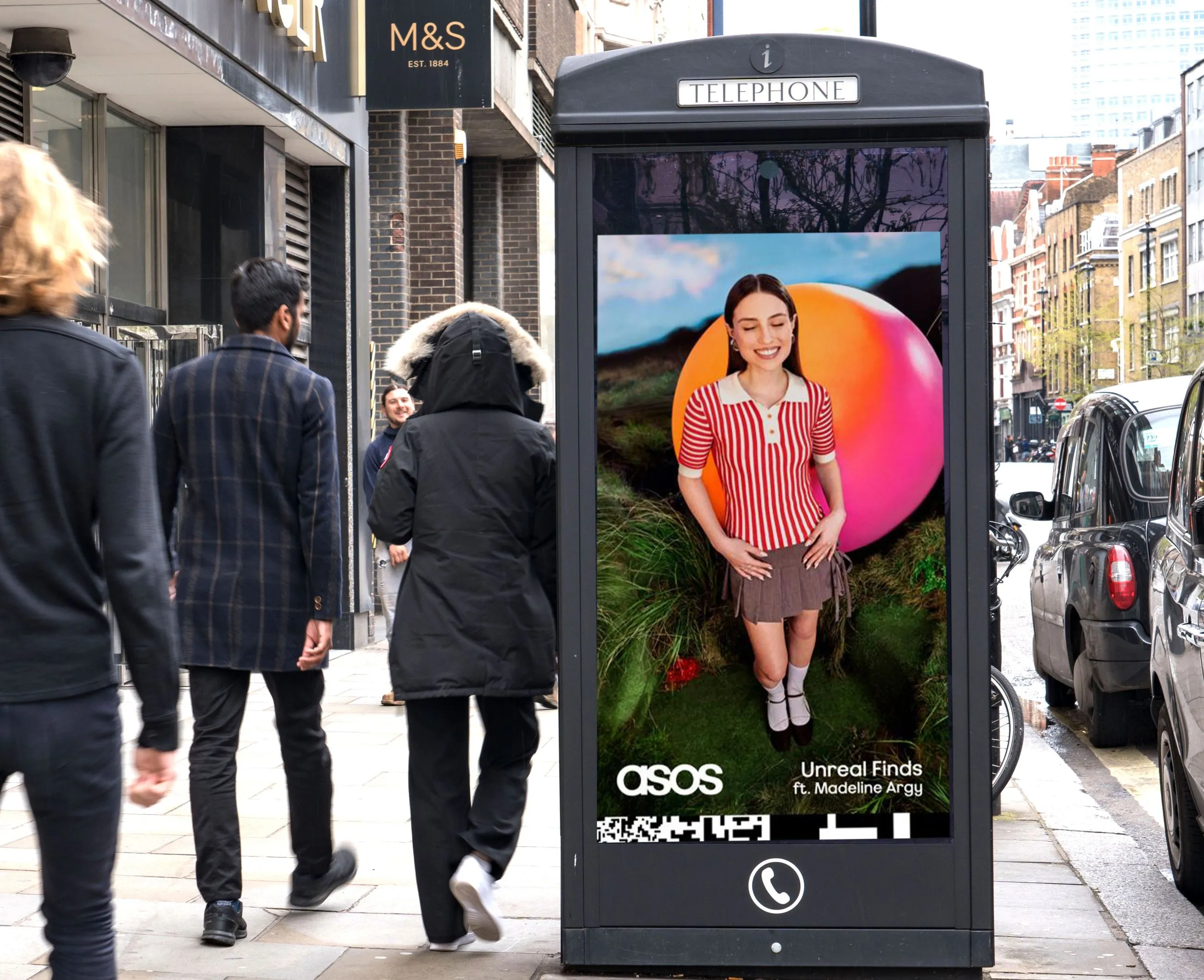 ASOS advertisement on a busy high street promoting clothing labelled as "unreal finds"