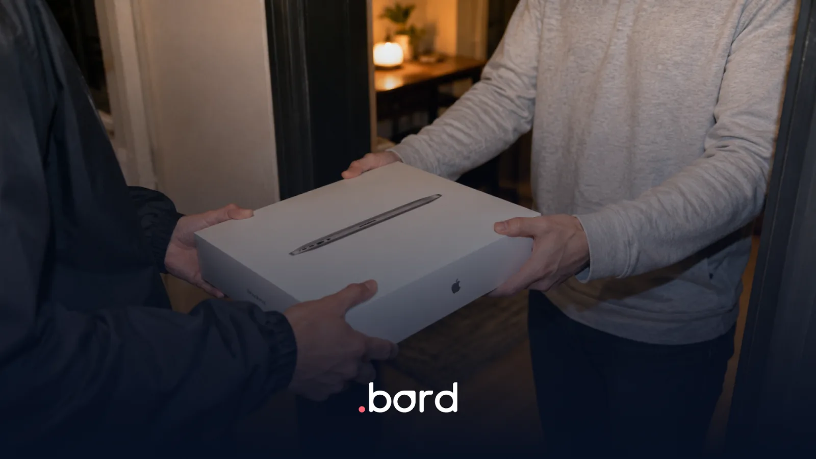 A MacBook box handed over at the door of a home. .bord logo